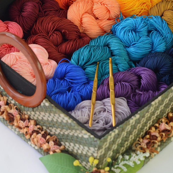 Coffee mug on a table with some knitting in progress