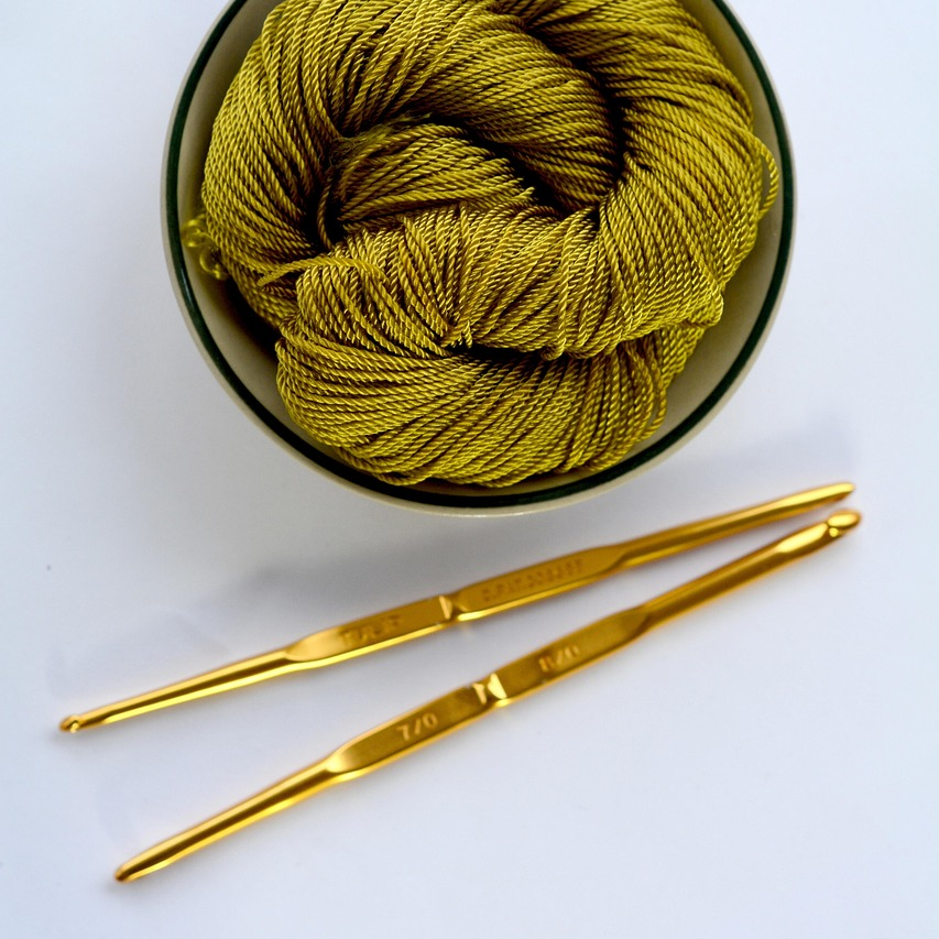 Crochet hooks and a ball of yarn