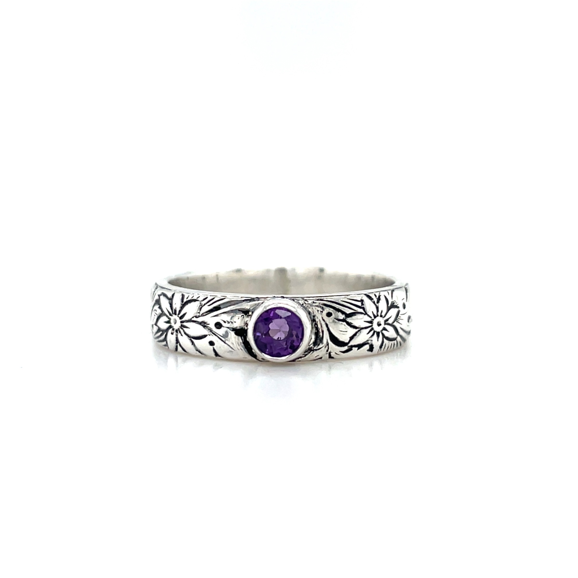 Sterling silver with oxidized floral stampings and a Bezel set Amethyst, size 8.5 5mm wide