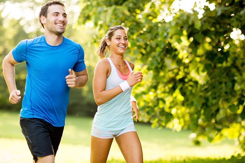 Fit Couple Running through a Park