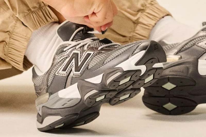 Close up of a gray and black New Balance shoe on a foot