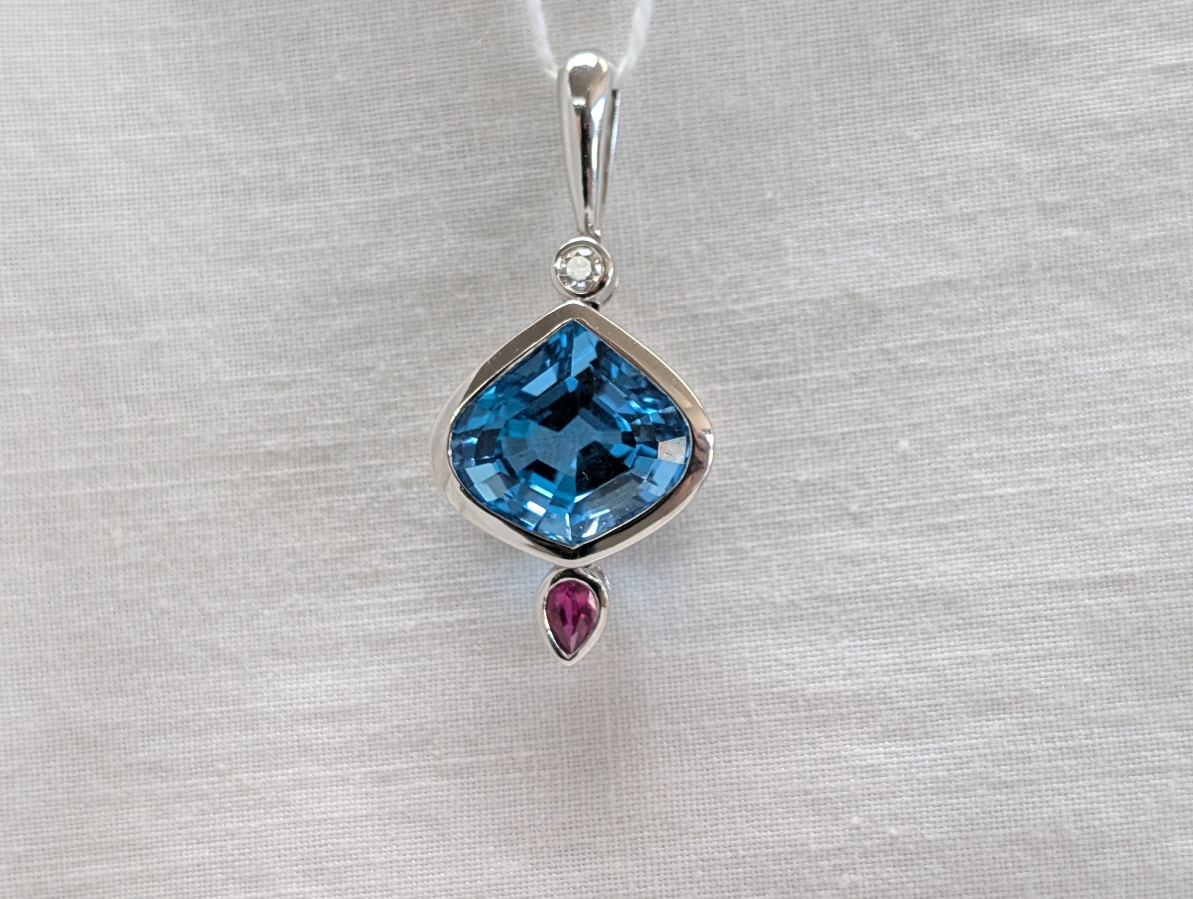 14kt WG Bezel 7.94ct special cut Blue Topaz, .16ct PS Ruby and .105ct Diamond Pendant 19-4-4581 FGTETFT