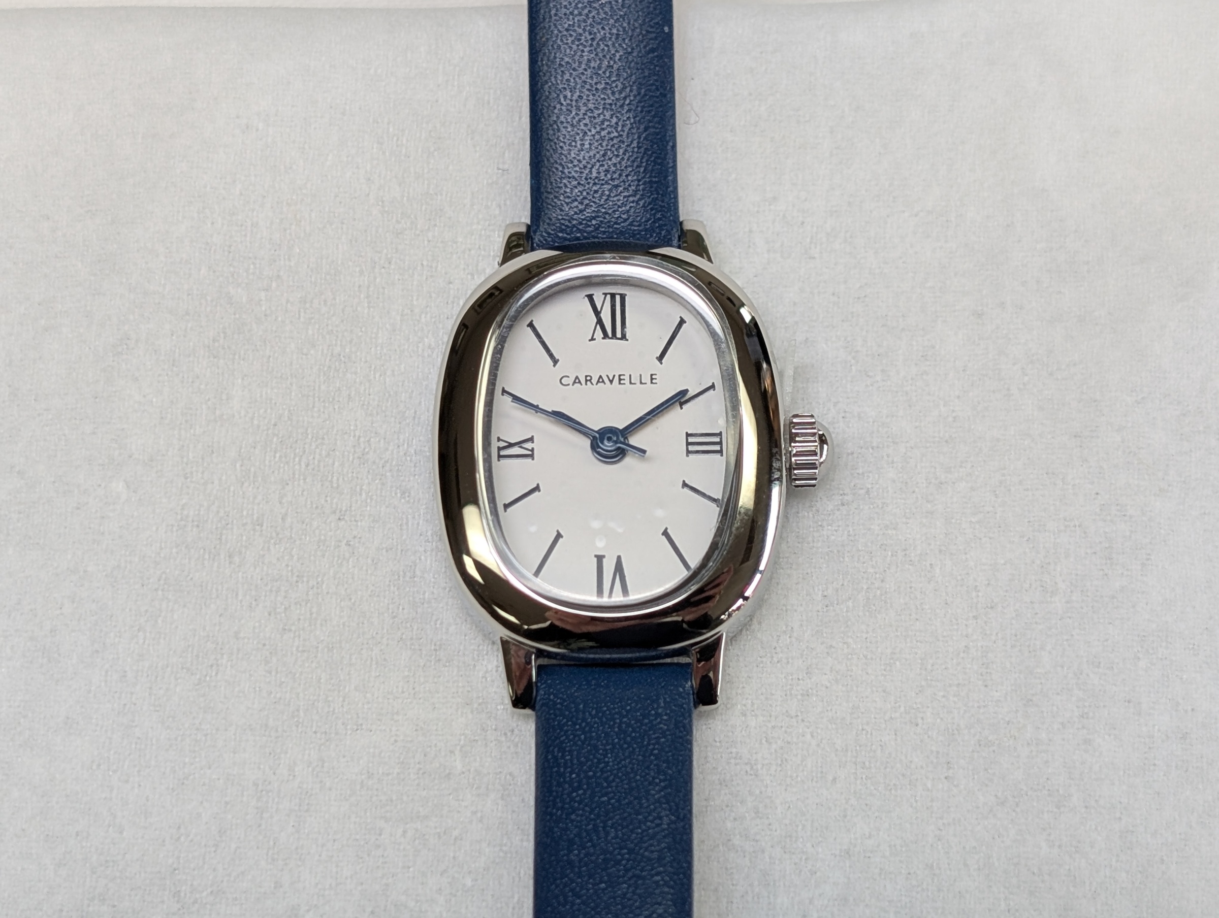 Ladies white Caravelle watch with white dial , blue hands, and blue strap 26-11-1282 FHETF