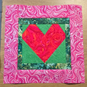 Pink Heart on Green Background