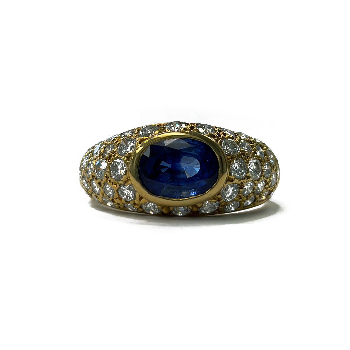 Estate Ring featuring a 1.50ct Oval Shape Blue Sapphire Bezel Set with 1.50cttw Pavé Set Diamond Accents in a Domed 18K Yellow Gold Band