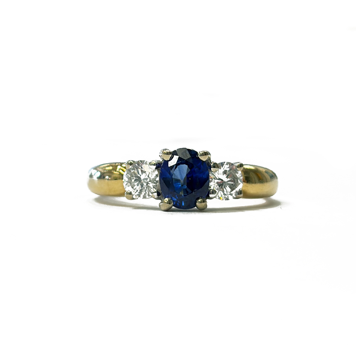 Three Stone Estate Ring Featuring a 0.75ct Oval Shape Royal Blue Sapphire Accented by 0.38cttw Brilliant Cut Diamond Accents Prong Set in Two-Tone 18K Gold