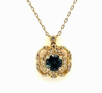 18 14 K Y .62ctw round faceted Montana Sapphire, .14ctw diamond accent pendant with chain necklace
