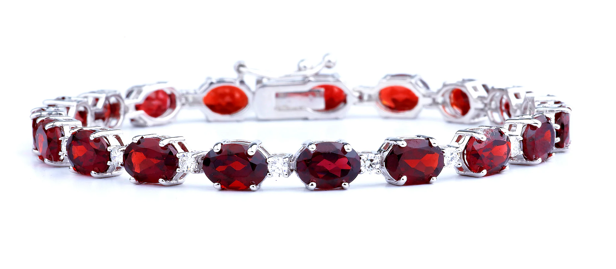 12.16 Grams 14K White Gold Bracelet With 19 Oval 7mm*5mm Prong Set Garnets Totaling 18.58ct & 19 Round Brilliant Prong Set Diamonds Of F Color, VS Clarity Totaling 0.78ct; DJ1858G78D