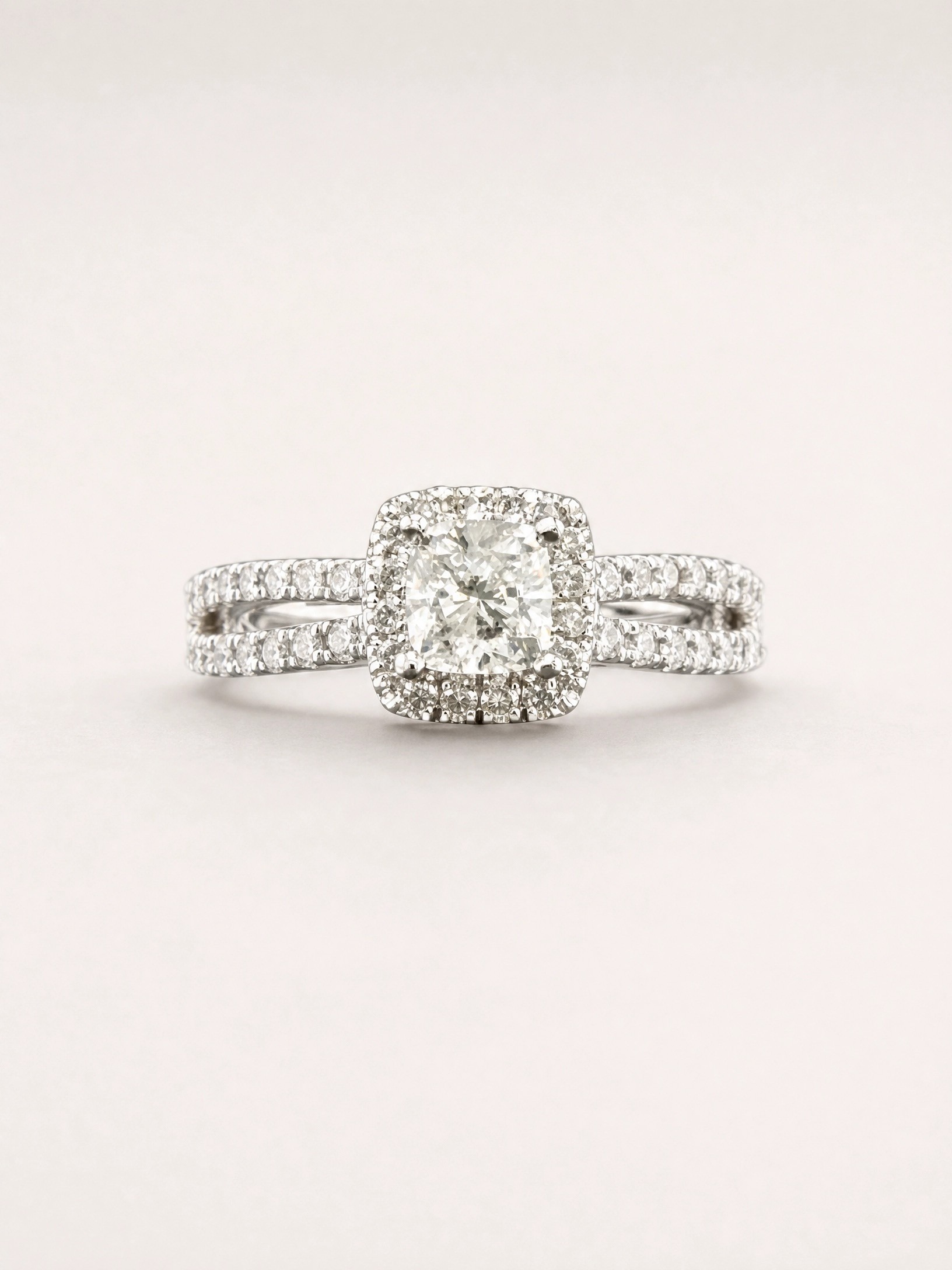 I am Canadian diamond ring with .53ct I1-F Cushion cut in centre with 52 round side diamonds on split shoulders .35ctw 14K White gold, CERT#1280 tracking #MLR250560
