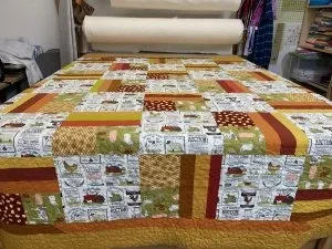 red yellow and gols rectangles with large squares of kitchen utensils, and fruits. 