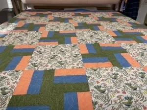 big squares patchwork quilt top with green,blue and floral retangles. 