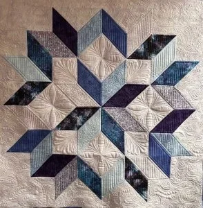 custom puples, lavendars light blue and light pastel lavendar,every square and retangle and all open spaces are very densely custom quilted.