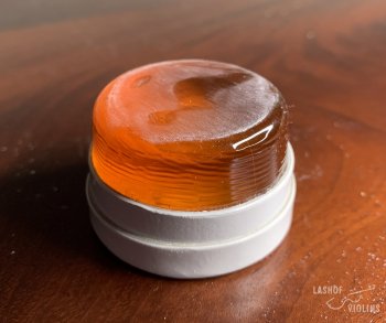 A barely scuffed rosin which has only been used on a violin bow.