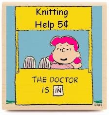 Lucy from Peanuts with pink hair in a booth labeled "knitting help 5 cents - the doctor is  IN"